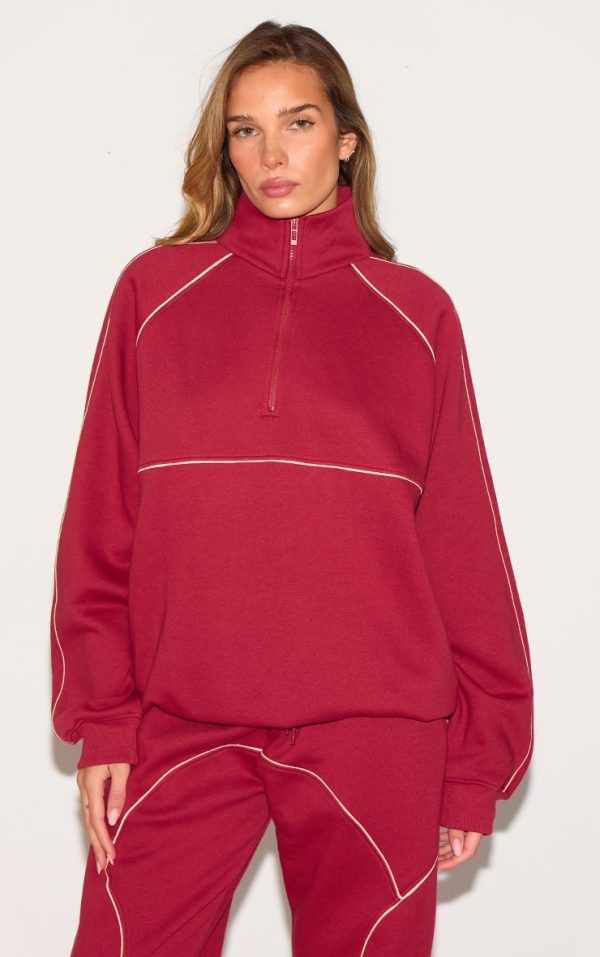 19b31b84aee63dec70d1d4536ff0f15a4456fac3_CNM4812_1_red_oversized_contrast_piping_quarter_zip_sweatshirt