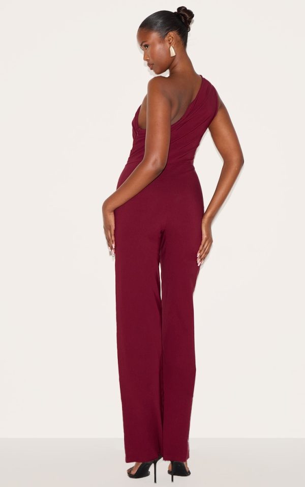 4326e99a323f4981cd9865c6a6ff881ff832892e_CNM3112_2_wine_stretch_woven_one_shoulder_ruched_flared_jumpsuit