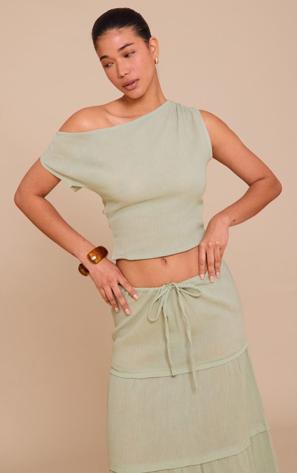 487c8db0c4b9b974365a72b72012464b2be0ab96_CNM6086_1_sage_green_cheesecloth_off_the_shoulder_asymmetric_top