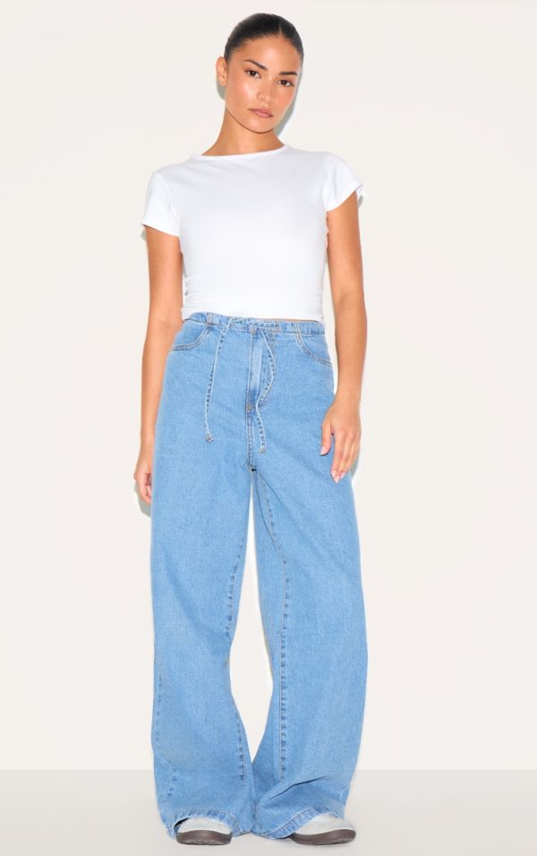 562b8e20a4fa5af98478e8c5b5912ac36628882b_CNL7054_1_petite_mid_blue_wash_low_rise_tie_waistband_wide_leg_jeans
