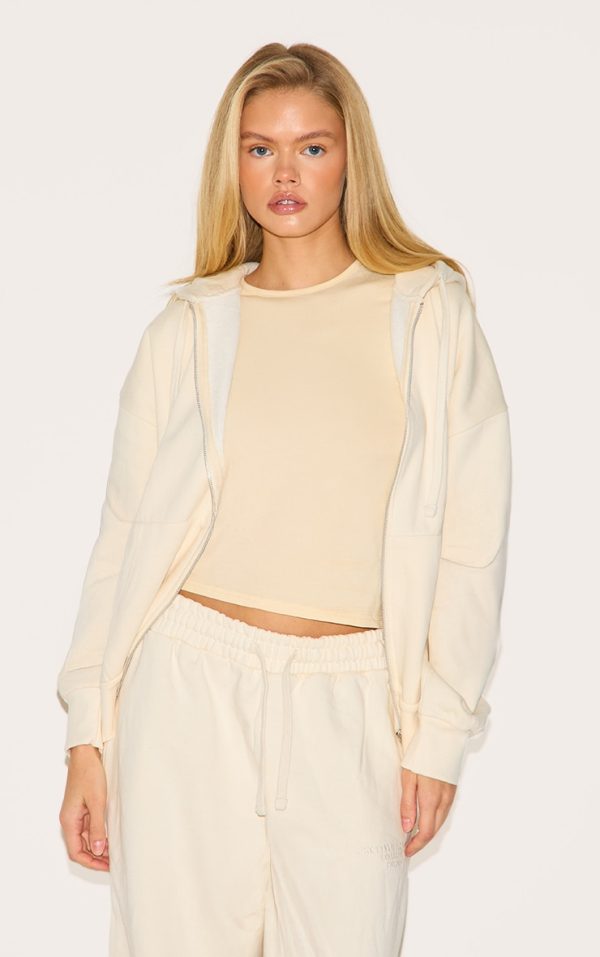 781fcbbd7f42a88cd6c1814baf5c81fdec2847bb_CNK1748_1_prettylittlething_cream_premium_embroidered_zip_front_oversized_hoodie
