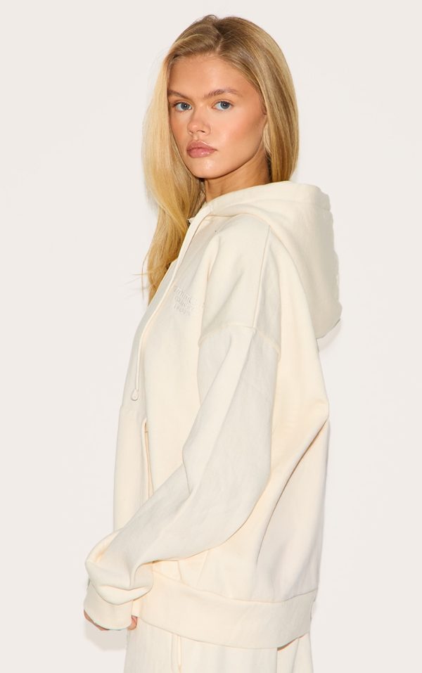 c53bd2510b500fe7a1aedc933349899944e3cc68_CNK1748_2_prettylittlething_cream_premium_embroidered_zip_front_oversized_hoodie