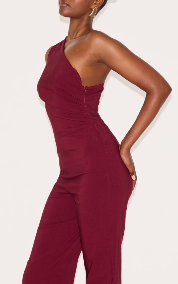 df9de893672c575d85ec47f25b217098555ded0b_CNM3112_4_wine_stretch_woven_one_shoulder_ruched_flared_jumpsuit