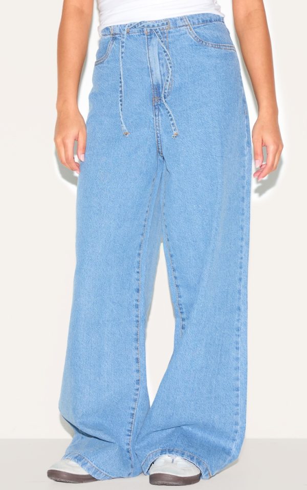 e94db44414df512d252de93e0d91263e69c38dc9_CNL7054_2_petite_mid_blue_wash_low_rise_tie_waistband_wide_leg_jeans