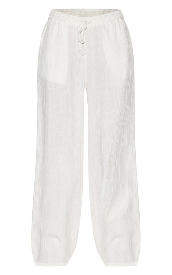 fe0c7399a3b886ee68e3c8bff1d4e60aa08bd7bc_CNM3210_5_white_textured_mid_rise_wide_leg_trousers